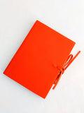 Orange soft leather journal with ties, blank pages