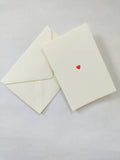 Folding card with hand embossed red heart and envelope