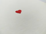 Folding card with hand embossed red heart