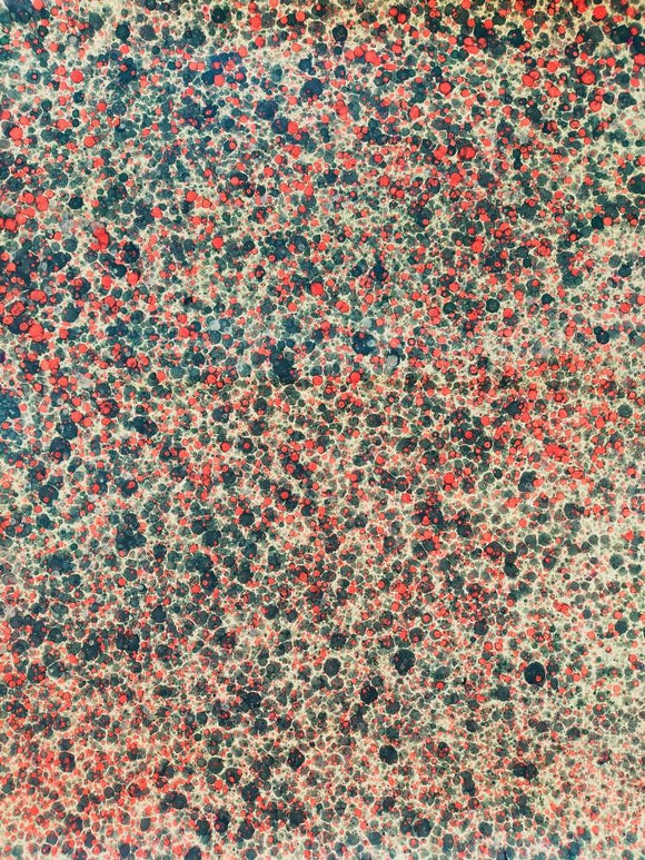 Hand marbled sheet of paper red dots