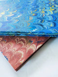 Marbled A4 guest book, brown or green and blue with decorated paper edge. Lined pages