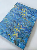 Marbled A4 guest book, green and blue with decorated paper edge. Lined pages