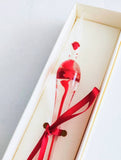 Clear Muirano glass pen and glass nib with swirly ink inside. Red set with ink, boxed