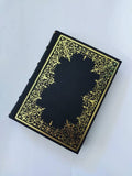 Black Italian leather journal with hand tooled gold leaf cover and spine, marbled end paper