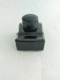 Vintage inkwell/pen rest, filled with black ink