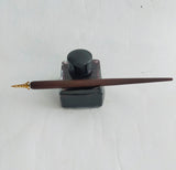 Vintage inkwell/pen rest, filled with black ink