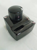 Vintage inkwell/pen rest, filled with black ink